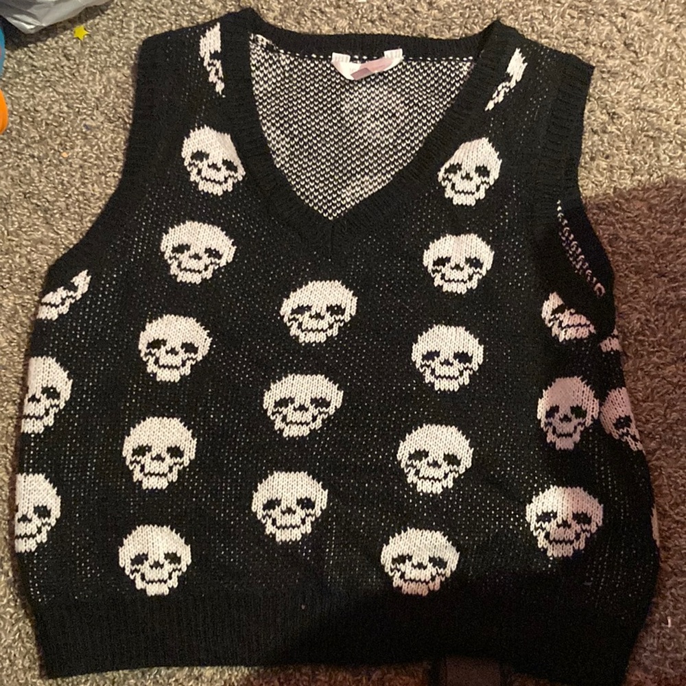 It’s a sweater vest with skulls on it and it’s low v neck and cropped